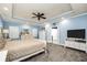Bright main bedroom with neutral colored carpet, modern ceiling fan, and recessed lighting at 704 Branchview Ct, Mcdonough, GA 30252