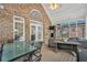 Outdoor patio with brick walls, a ceiling fan, and seating areas at 704 Branchview Ct, Mcdonough, GA 30252