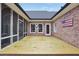 Back patio featuring outdoor seating, brick walls, and access to the screened-in porch at 704 Branchview Ct, Mcdonough, GA 30252