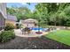 Inviting patio with an umbrella and dining set with lovely landscaping at 704 Branchview Ct, Mcdonough, GA 30252