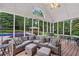 Enclosed patio boasts comfortable seating, outdoor dining, and a view of the backyard pool at 704 Branchview Ct, Mcdonough, GA 30252