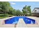 A diving board sits over the backyard swimming pool of this estate home at 704 Branchview Ct, Mcdonough, GA 30252