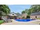 Beautiful backyard pool with lounge chairs, tables, and a screened in porch with dining at 704 Branchview Ct, Mcdonough, GA 30252