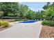 Inviting backyard pool with a diving board surrounded by lush landscaping and greenery at 704 Branchview Ct, Mcdonough, GA 30252