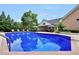 Inviting pool with sun shelf and brick surround near the home at 704 Branchview Ct, Mcdonough, GA 30252