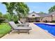 Spacious outdoor patio with pool, lounge chairs, and backyard at 704 Branchview Ct, Mcdonough, GA 30252