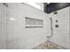 Elegant walk-in shower with marble tiling, a pebble floor, and a rainfall shower head at 704 Branchview Ct, Mcdonough, GA 30252