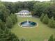 Expansive estate featuring a grand home, circular water fountain, surrounded by lush greenery at 1822 Chartwell Trce, Stone Mountain, GA 30087