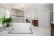 Bright bathroom featuring a soaking tub with chandelier, glass shower, and decorative tiling at 1822 Chartwell Trce, Stone Mountain, GA 30087