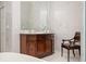 Bathroom featuring marble tiling and a dark wood vanity cabinet with elegant fixtures and accessories at 1822 Chartwell Trce, Stone Mountain, GA 30087
