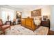 Bedroom with wooden bed frame, decorative tapestry, ornate rug, and stylish furniture at 1822 Chartwell Trce, Stone Mountain, GA 30087