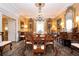 Formal dining room featuring a long table and chairs, a sparkling chandelier, and beautiful artwork at 1822 Chartwell Trce, Stone Mountain, GA 30087