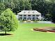 Beautiful white home with a manicured lawn and a fountain at 1822 Chartwell Trce, Stone Mountain, GA 30087