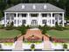Stunning exterior elevation of a white home with black shutters and large column lined porch at 1822 Chartwell Trce, Stone Mountain, GA 30087