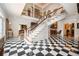 Grand foyer with black and white marble floors and a curved staircase at 1822 Chartwell Trce, Stone Mountain, GA 30087
