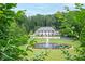 Grand estate showcasing a circular fountain, manicured lawn, and lush landscaping at 1822 Chartwell Trce, Stone Mountain, GA 30087