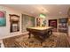Spacious game room featuring a billiards table, decorative rug, and custom light fixture at 1822 Chartwell Trce, Stone Mountain, GA 30087