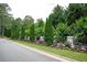 Beautifully landscaped yard with mature trees, flowering plants, and manicured hedges at 1822 Chartwell Trce, Stone Mountain, GA 30087
