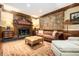 Living room featuring a fireplace, rich wood trim, leather sofa and ottoman, creating a cozy space at 1822 Chartwell Trce, Stone Mountain, GA 30087