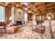 Cozy living room with wood paneled walls, stone fireplace, and plush seating at 1822 Chartwell Trce, Stone Mountain, GA 30087