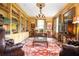 Spacious office with custom built-in bookshelves, elegant chandelier, and vintage accents at 1822 Chartwell Trce, Stone Mountain, GA 30087