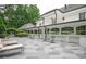 Stunning patio area with stone tiling, lounge chairs, and the architecture of the house with large windows in the background at 1822 Chartwell Trce, Stone Mountain, GA 30087
