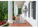 A long porch features decorative rocking chairs and outdoor decor at 1822 Chartwell Trce, Stone Mountain, GA 30087