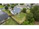 Aerial view of a spacious backyard featuring a well-maintained lawn, privacy fence, and patio with outdoor seating at 3834 Hawk Tail Dr, Loganville, GA 30052