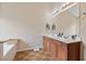 Bathroom featuring double sinks, tiled floor, vanity, and mirror at 3834 Hawk Tail Dr, Loganville, GA 30052