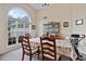 Bright dining area with large arched window, beige walls, and neutral carpet at 3834 Hawk Tail Dr, Loganville, GA 30052