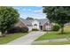 Charming single-Gathering home with brick accents, a well-manicured lawn, and a driveway leading to a single-car garage at 3834 Hawk Tail Dr, Loganville, GA 30052