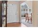 Inviting foyer boasts hardwood floors, a white door, and an arched window over a dining area at 3834 Hawk Tail Dr, Loganville, GA 30052