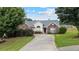 Charming brick home with a well-manicured lawn and mature trees offering great curb appeal at 3834 Hawk Tail Dr, Loganville, GA 30052