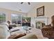 Comfortable living room featuring a decorative fireplace, ceiling fan, and sliding doors leading to the backyard at 3834 Hawk Tail Dr, Loganville, GA 30052