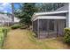Backyard of house with a screened in porch and green grass at 1908 Brittania Cir, Woodstock, GA 30188