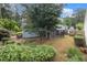 Backyard with a view of screened-in porch and blue siding house at 1908 Brittania Cir, Woodstock, GA 30188
