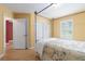 Bedroom featuring light-colored walls, a four-post bed and access to storage and other rooms at 1908 Brittania Cir, Woodstock, GA 30188