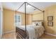 Bedroom featuring light-colored walls, a four-post bed and a window with plantation shutters at 1908 Brittania Cir, Woodstock, GA 30188
