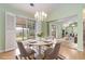 Dining area featuring a modern chandelier, access to the patio and view to the living room at 1908 Brittania Cir, Woodstock, GA 30188