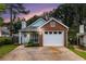 Exterior view of house with blue siding, brick, a garage, and a driveway at 1908 Brittania Cir, Woodstock, GA 30188