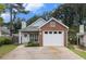 Charming single-story home featuring a brick facade, attached garage, and well-manicured front yard at 1908 Brittania Cir, Woodstock, GA 30188