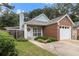 Inviting single-Gathering home with a brick and siding exterior, featuring a well-kept lawn and attached garage at 1908 Brittania Cir, Woodstock, GA 30188