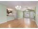 Open floor plan featuring hardwood floors, vaulted ceiling, and a fireplace with a view of the kitchen at 1908 Brittania Cir, Woodstock, GA 30188