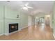 Spacious living room featuring hardwood floors, vaulted ceiling, and a cozy fireplace with light green walls at 1908 Brittania Cir, Woodstock, GA 30188