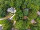 Stunning aerial view of a home nestled among lush, mature trees, offering privacy and seclusion at 320 Yellowroot Ln, Sandy Springs, GA 30350