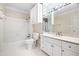 White tiled bathroom with a white vanity and a shower and tub at 320 Yellowroot Ln, Sandy Springs, GA 30350