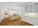 Bright kitchen with white cabinets, hardwood floors, granite countertops and an island at 320 Yellowroot Ln, Sandy Springs, GA 30350