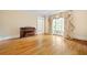 Formal living room with hardwood floors and a window with curtains and an antique piano at 320 Yellowroot Ln, Sandy Springs, GA 30350