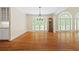 Open living room featuring hardwood floors, a decorative chandelier, and access to the outdoor balcony at 320 Yellowroot Ln, Sandy Springs, GA 30350