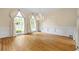 Formal living room featuring large windows with curtains, decorative molding, and hardwood floors at 320 Yellowroot Ln, Sandy Springs, GA 30350